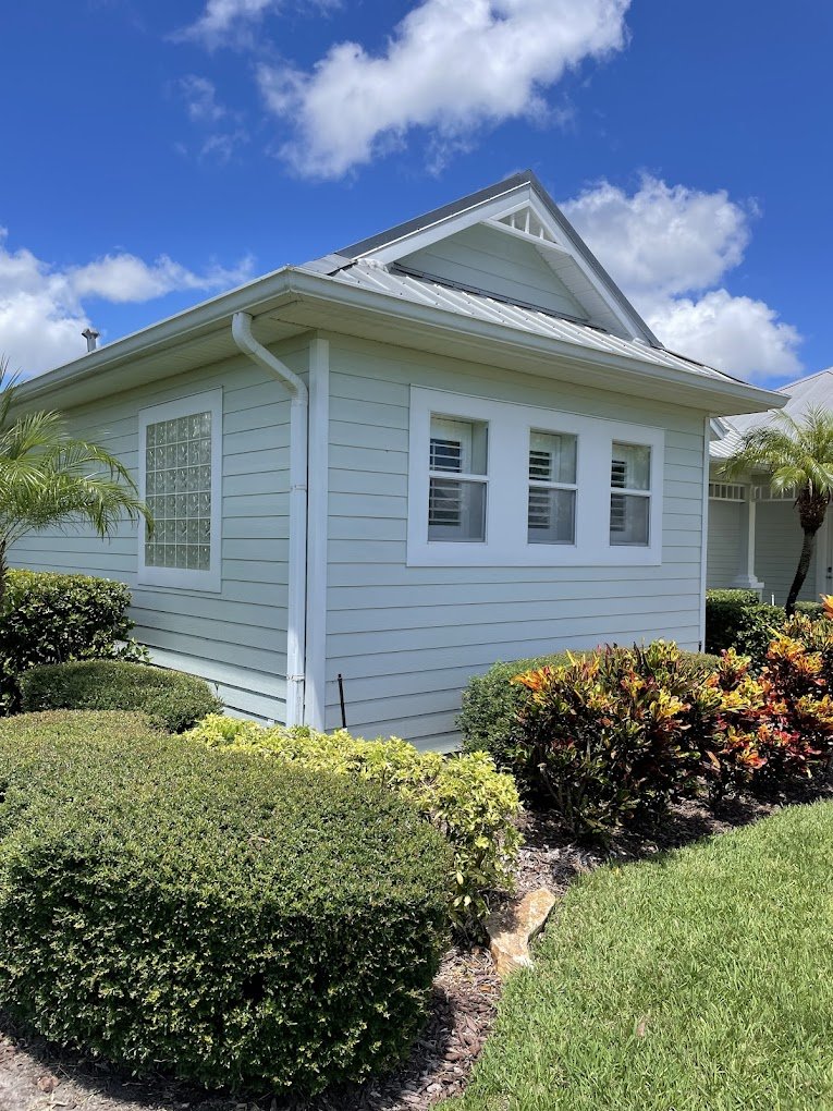 Clean white gutters and siding after professional gutter cleaning in Brevard County, Florida — showcasing Suncoast Softwash’s safe, damage-free exterior wash process.
