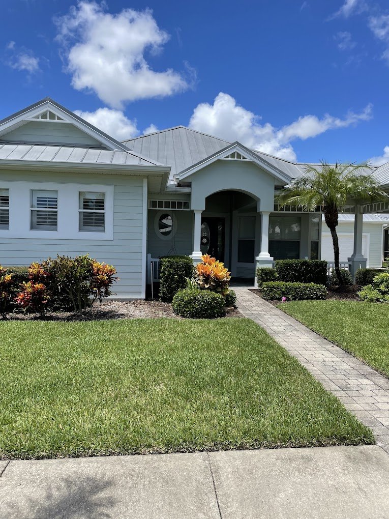 Clean Florida home with a freshly washed metal roof after professional roof cleaning in Brevard and Volusia County by Suncoast Softwash.