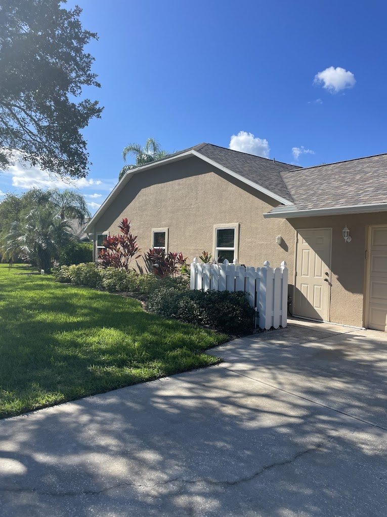 Clean residential roof and driveway after roof cleaning in Brevard and Volusia County by Suncoast Softwash.